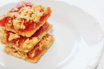 Raspberry jam and shortbread pie on a white plate