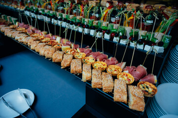 On a warm day, food is on the table during a buffet table