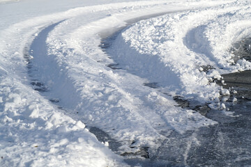 Fototapeta na wymiar tire tracks after snow storm on the street