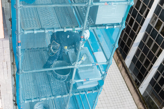 obrero aislando una fachada con paneles aislantes de foam