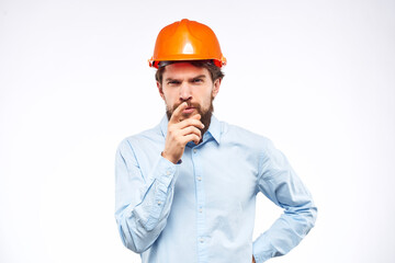 Man in blue shirt orange hard hat professional construction safety engineer