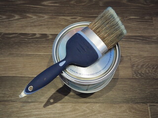 Paint brush on top of tin of paint
