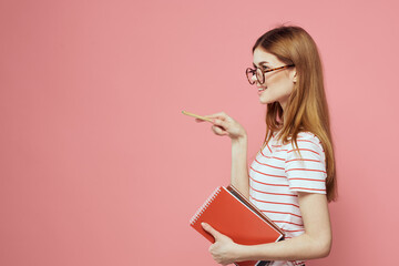beautiful female student holding books education institute gesturing with hands pink background Copy Space