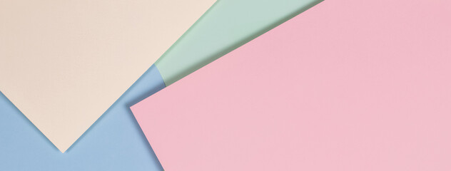 Abstract geometric texture background of fashion soft green, pastel pink, light blue, yellow color paper. Top view.