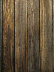 Naklejka premium A background of dark wood planks tightly adjacent to each other. Wooden boards with a clearly visible wood texture.