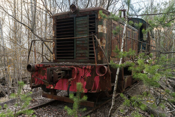 Fototapeta na wymiar Old radioactive locomotion at abandoned station Yanov