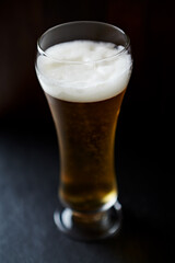 Glass of beer on dark background. Close up. 