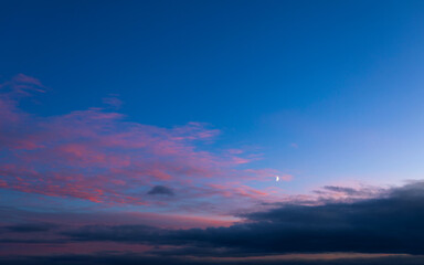 Background of mystery purple and pink clouds on blue sky at evening after sunset. Wide angle photo shot