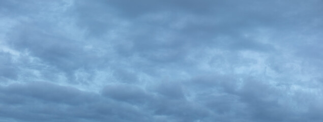 Background of gray clouds at sky at dawn. Long panoramic banner