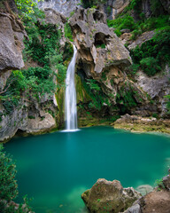 The skull waterfall with natural turquoise water pool. Spain