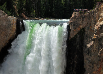View To The Lower Yellowstone Falls From Red Rock Point On A Sunny Summer Day With A Clear Blue Sky...