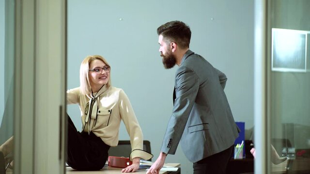 Sexy Secretary seducing her boss. Sexual harassment and office abuse concept. Young boss seduces female employee. Abuse of work status.