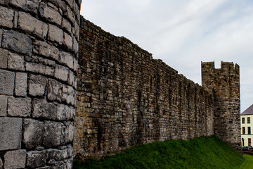 Beautiful royal town of Caernarfon, Wales. Historic city walls.  Dramatic structure around the charming old quarter.