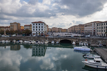 Fototapeta premium view of the ancient buildings and the canal with boats within the city