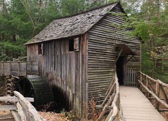 Fototapeta na wymiar Old Water Mill Cable Mill With Paddle Wheel At Cherokee Orchard Road In Great Smoky Mountains National Park On A Cloudy Autumn Day