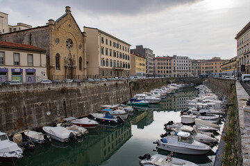 view of the ancient buildings and the canal with boats within the city