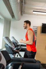 Man running on a treadmill at health club