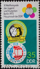 GERMANY, DDR - CIRCA 1973 : a postage stamp from Germany, GDR showing Youth emblems and a globe sign. Text: World Festival of Youth and Students Berlin 1973, capital of the GDR
