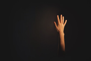 Hand of a woman on a black background