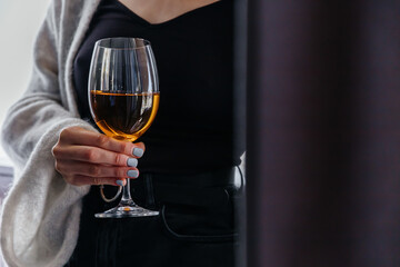 wine in a glass in the hands of a young girl