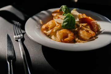 shrimp salad on a black background with beautiful shadows. Top view