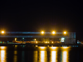 Fototapeta na wymiar Night view of a seaport with a metal structure illuminated by bright lights