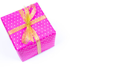 bright gift box with gold ribbons on white background.