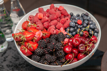 White plate with berries on the table