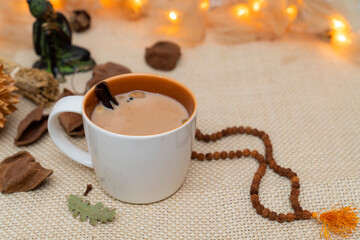 Yogi cinnamon tea on meditation decoration background. Alternative medicine with herbal tea....