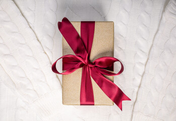 beautiful gift box with red bow knot on white sweater