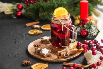 Christmas hot mulled wine with cinnamon cardamom and anise. Dark vintage dirty background. Creative atmospheric decoration