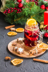Christmas hot mulled wine with cinnamon cardamom and anise. Dark vintage dirty background. Creative atmospheric decoration