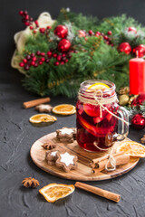 Christmas hot mulled wine with cinnamon cardamom and anise. Dark vintage dirty background. Creative atmospheric decoration