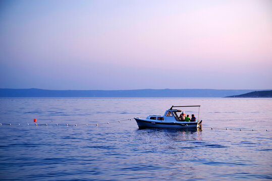 Image of a fishing boat against the sunset background