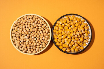 Chickpeas in small yellow ceramic plate bowl isolated on beige orange background.vegetarian dish. on bowl close up - concept healthy vegan diet protein organic food dish