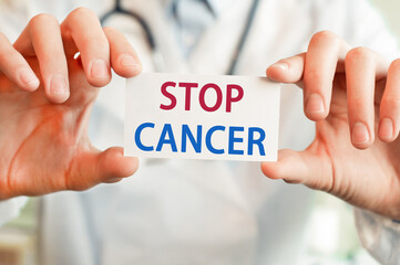 Doctor holding a card with text STOP CANCER, medical concept