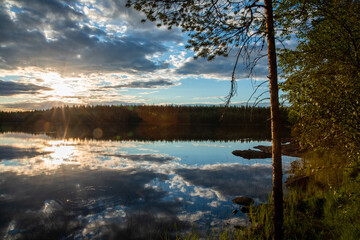 Evening sunset on the river. Boats stand near the shore.