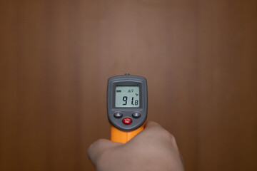 Holding a temperature meter