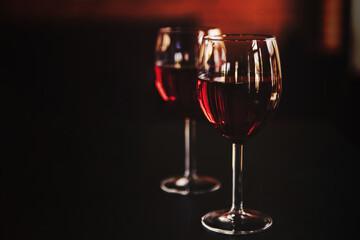 Two glasses of red wine for a couple in love on a black background