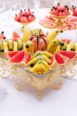 Banana, pomegranate, kiwi and pineapple and grapefruit buffet table at a wedding
