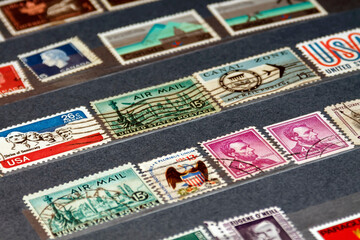 Various old postage stamps from usa in the philatelic album