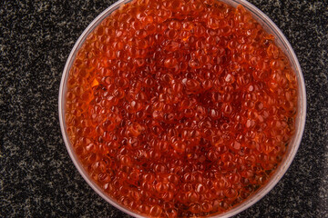 texture of red caviar, wooden spoon in red caviar
