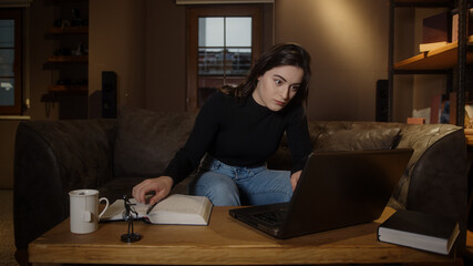 Young college or high school student pretty girl studying at table with laptop and pen paper, pandemic distance education concept