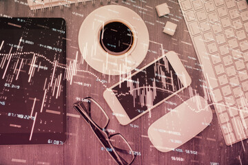Multi exposure of forex graph hologram over desktop with phone. Top view. Mobile trade platform concept.