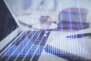 Double exposure of financial chart drawing and desktop with coffee and items on table background. Concept of forex market trading