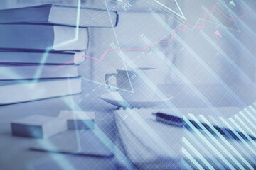 Fototapeta premium Double exposure of financial chart drawing and desktop with coffee and items on table background. Concept of forex market trading