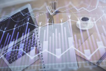 Double exposure of businesswoman hands typing on computer and forex chart hologram drawing....