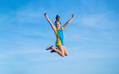 stretching and warming up. childhood happiness. health and fitness. gymnastics. sense of freedom. happy teen girl jump on sky background. kid has flexible body. child in sport clothes training