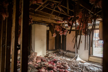 View of destroyed room with shattered ceiling, debris-covered floor