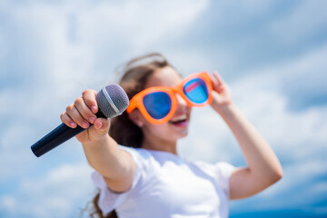 make your voice louder. Music and life. teen girl singing song with microphone. having a party. Happy kid with microphone. Singing Songs in karaoke. Lifestyle and People Concept. selective focus